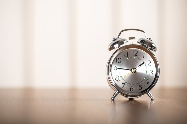 Retro alarm clock on table  background