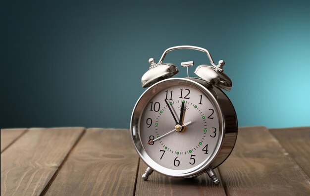 Retro alarm clock on table background