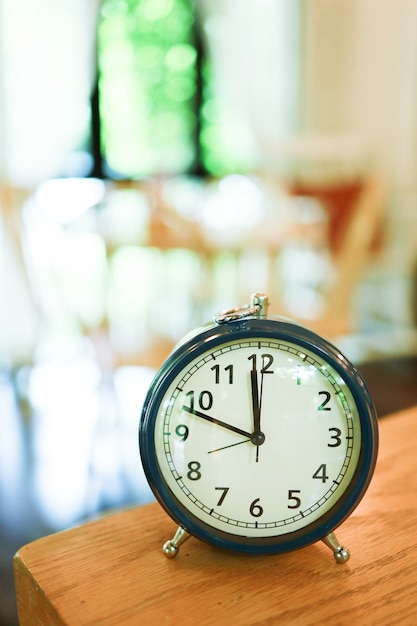 Retro Alarm clock on table in living room. Â vintage style Time of day .