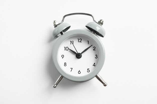 Retro alarm clock on white, space for text