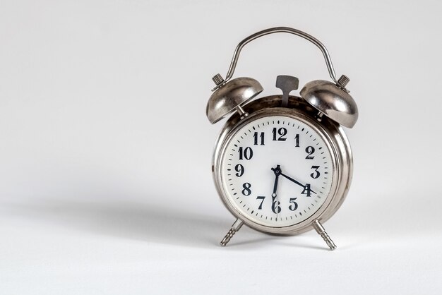 Retro alarm clock on white surface