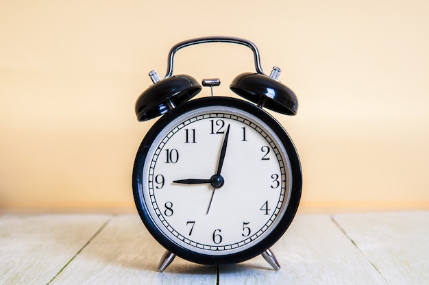 Retro alarm clock on wooden table