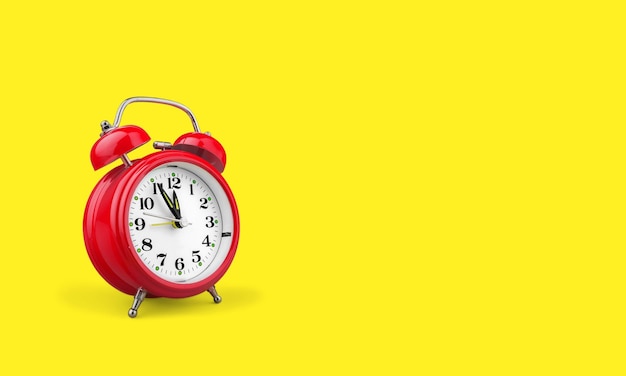 Retro alarm clock on yellow background