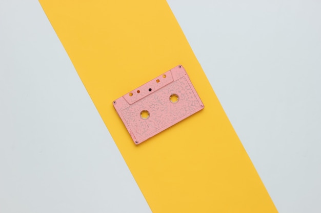 Retro audio cassette on a yellowwhite background