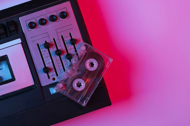 Retro audiobandrecorder, audiocassette in roze blauw verloop neonlicht