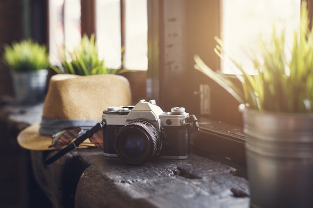 Retro camera with hat and sunglasses