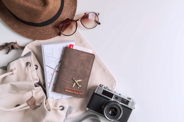 Retro macchina fotografica con accessori da viaggio e oggetti su sfondo bianco