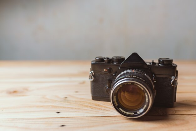 Retro camera on wood table background