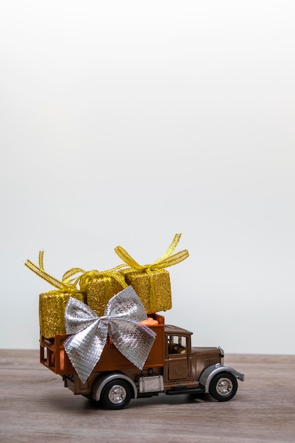 Retro car with gifts on a colored background. Vertical format with copy space. Festive concept