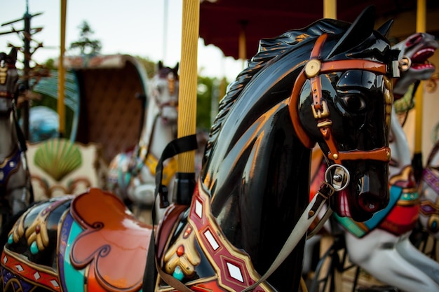 Retro carousel white black horse Old wooden horse carousel Carousel Horses on vintage