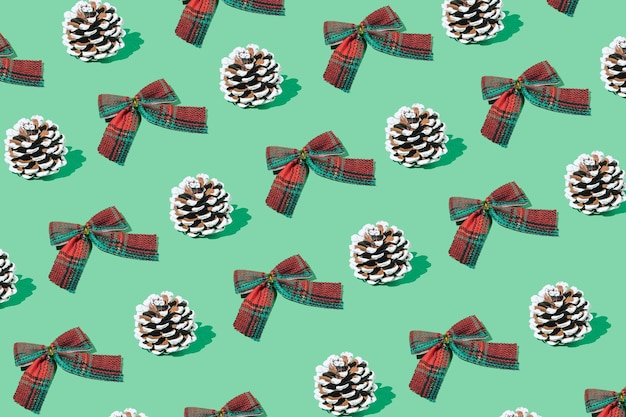 Photo retro christmas pattern with plaid bow and pine cones creative vintage winter concept