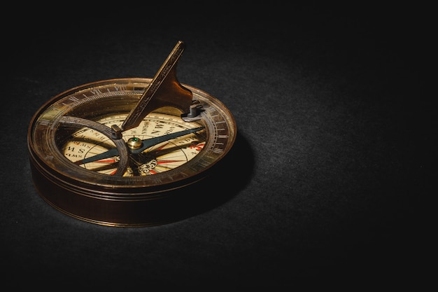 Retro compass on black board table.