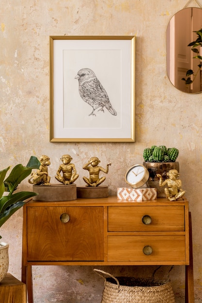 Retro composition of living room interior with wooden vintage commode, gold pink mirror, mock up poster frame, plant, decoration and elegant personal accessories in wabi sabi home decor.