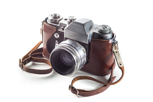 Photo retro film camera and belt bag (leather case) on white surface