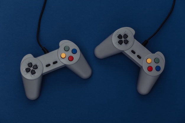 Retro gamepads on classic blue background. retro gaming. color
2020. top view.