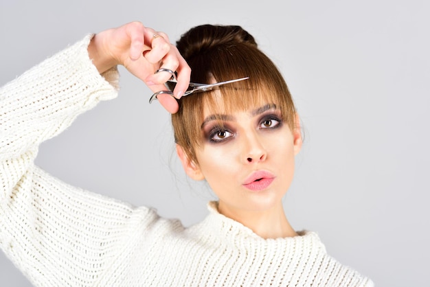 retro girl with elegant makeup on face retro girl cut hair with scissors