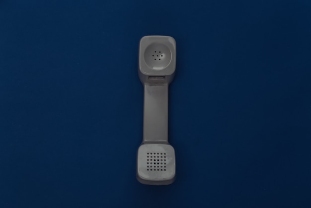 Retro handset on classic blue background. Color 2020. Top view.