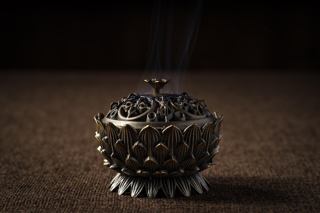 Retro incense burner on dark background