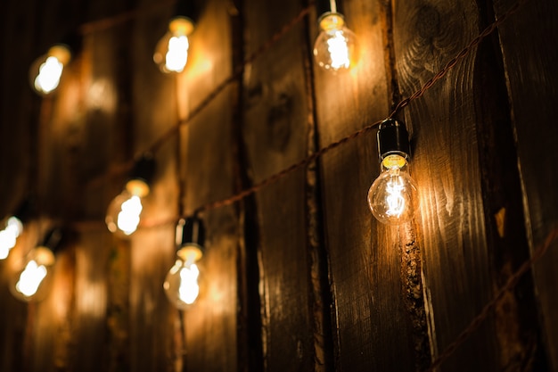 Retro Lamp With Plug And Cable Hanging On The Wooden Wall