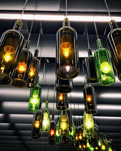 Retro light lamp decor made of empty wine bottles. Toned