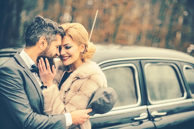 Retro look of couple in love retro car and happy couple in love outdoor