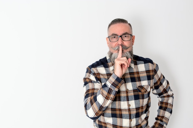 Retro-looking hipster with plaid shirt, beard, mustache and glasses