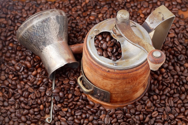 Retro manual coffee mill on roasted beans