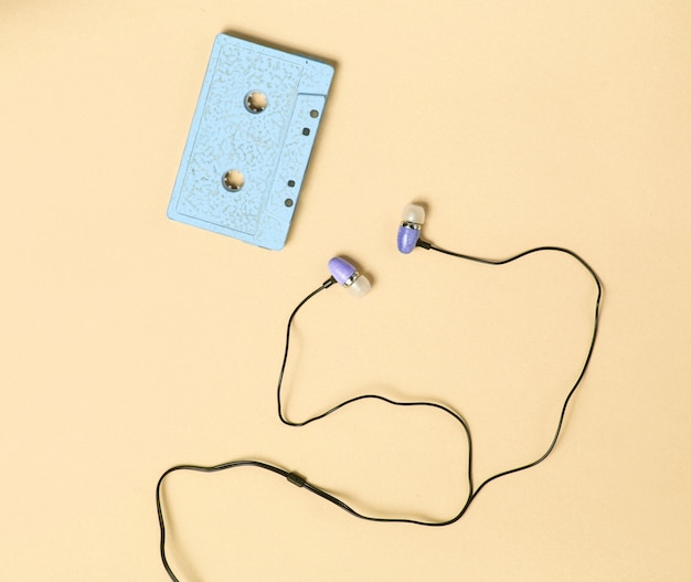 Retro media concept with vacuum earphones and cassette