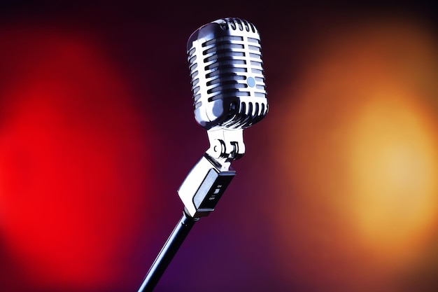 Retro microphone on colorful blurred background