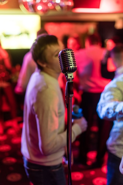 Retro microphone on stage in a pub or bar (restaurant) during a\
night show