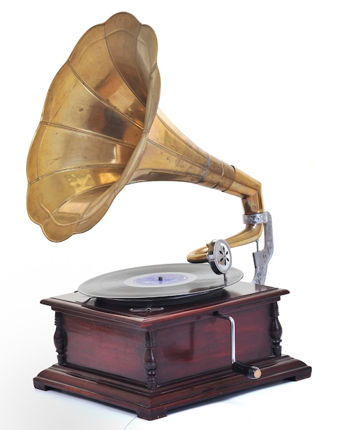 Photo retro old gramophone for playing music over plates  isolated on white in studio