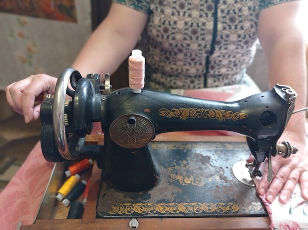 retro old sewing machine 50s of the 20th century work sewing woman's hands