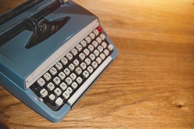 Retro old typewriter on blur background and front of wooden table Vintage concept