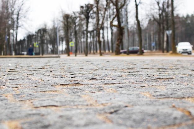 Retro paving slabs of stones on background of city