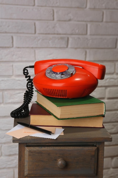 Retro phone on nightstand in room close up