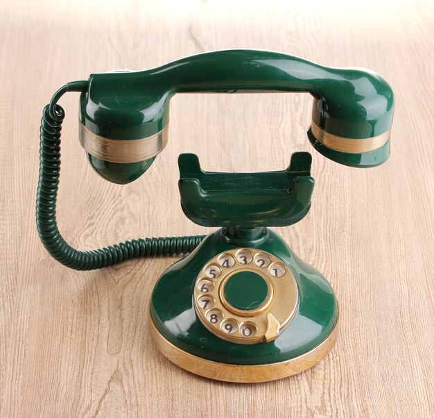 Retro phone with floating handset on wooden table