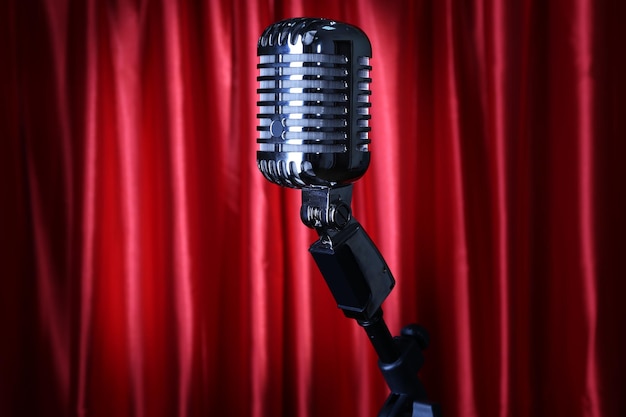 Photo retro silver microphone on red fabric background