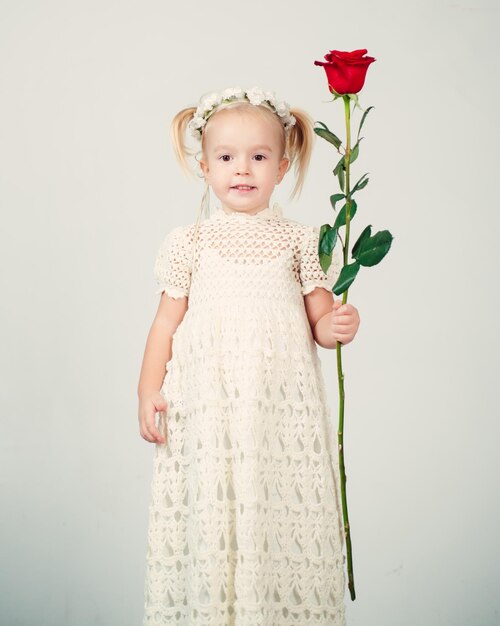 Retro style happy birthday wedding small kid with red rose happy childhood love present childrens day little girl in vintage dress Beauty valentines day romantic date All you need is love