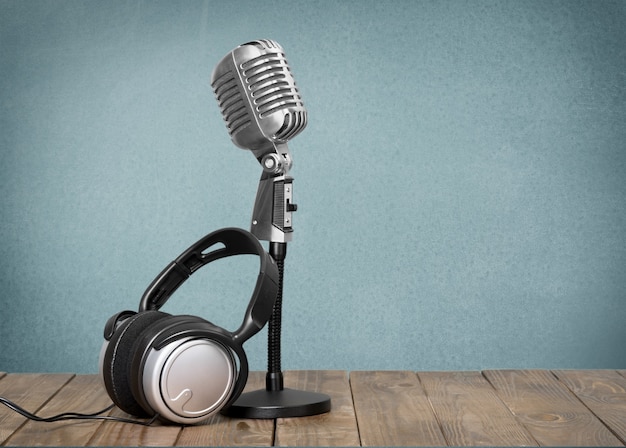 Retro style microphone and headphones on  background