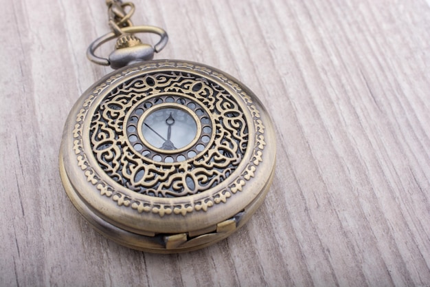 Retro style pocket watch ongrey background