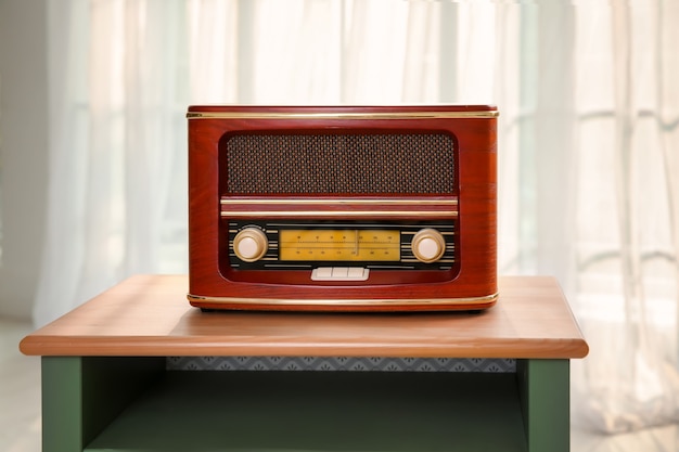 Photo retro style radio on table indoors