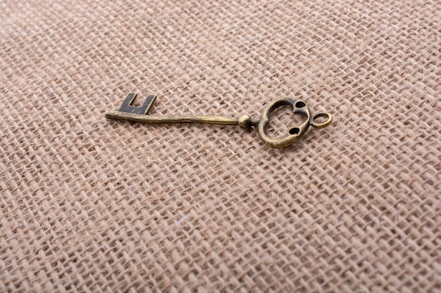 Retro styled key on a linen canvas