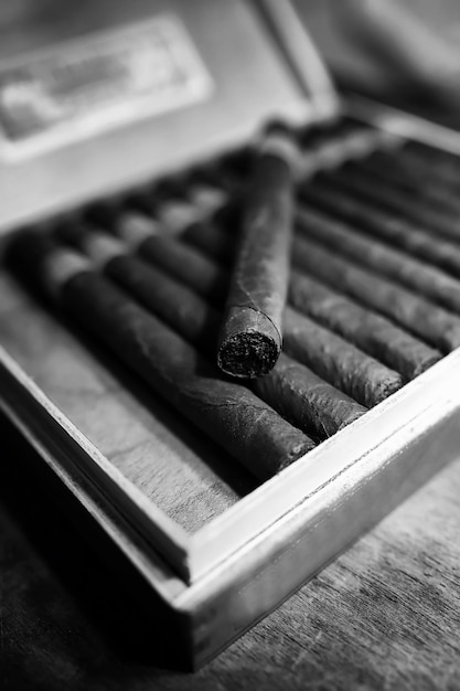 Retro styled photo of large box of Cuban cigars on a wooden table in a presentable package