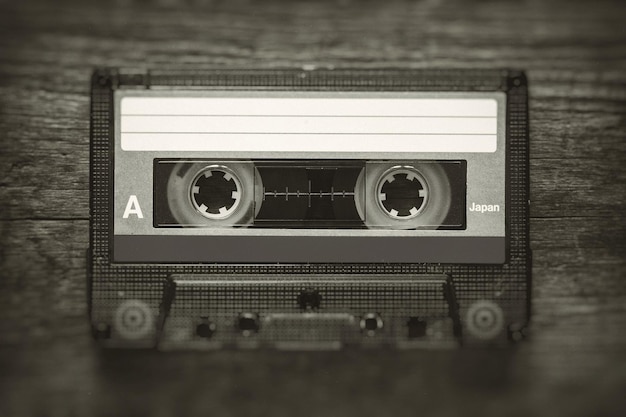 Retro stylized photo of vintage Audio cassette tape with blur and noise effect