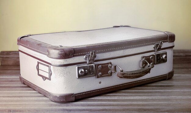 Retro suitcase put on wooden floor 