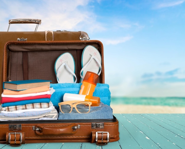 retro suitcase with travel objects on  background