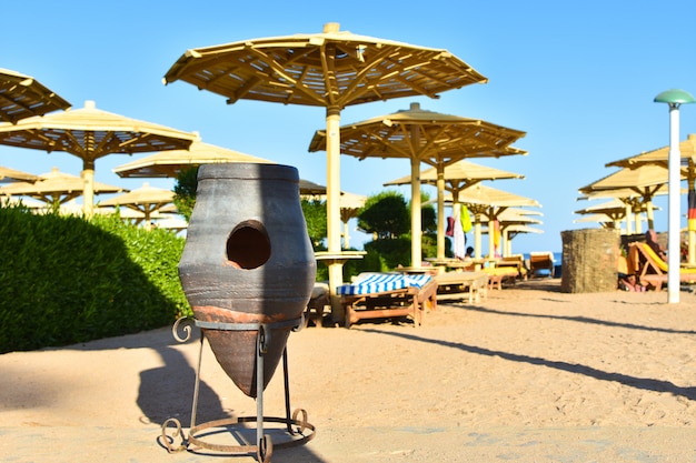 Retro trash bin on the beach in Egypt