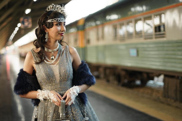 Retro vintage portrait of beautiful Gatsby woman stand look around, wait coming train for lover, feeling expression face romantic 20s fashion style at public train station, Gatsby old fashion concept