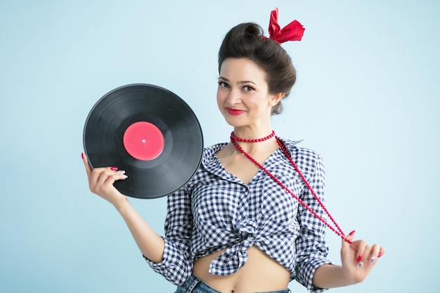 Retro woman in fifties style holds a musical record