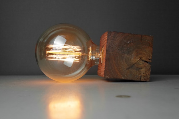 Retro wood lamp with Edison lamp on gray